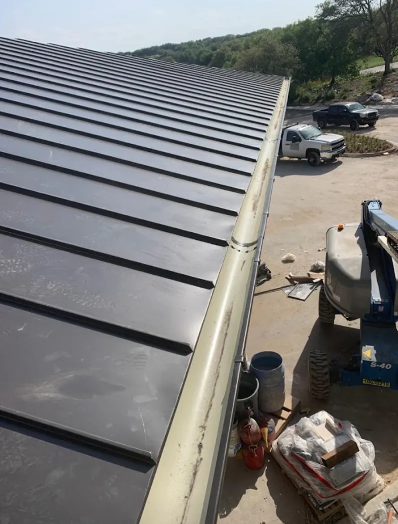 Standing seam panel and gutter detail on a metal roofing jobsite in Brookings